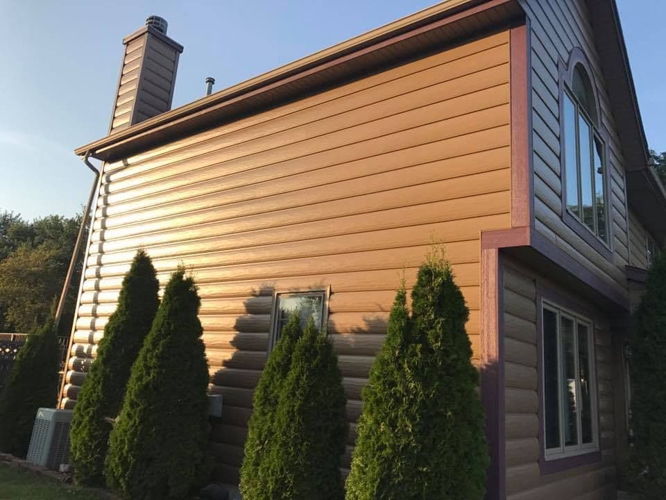 A house with new, medium brown siding.